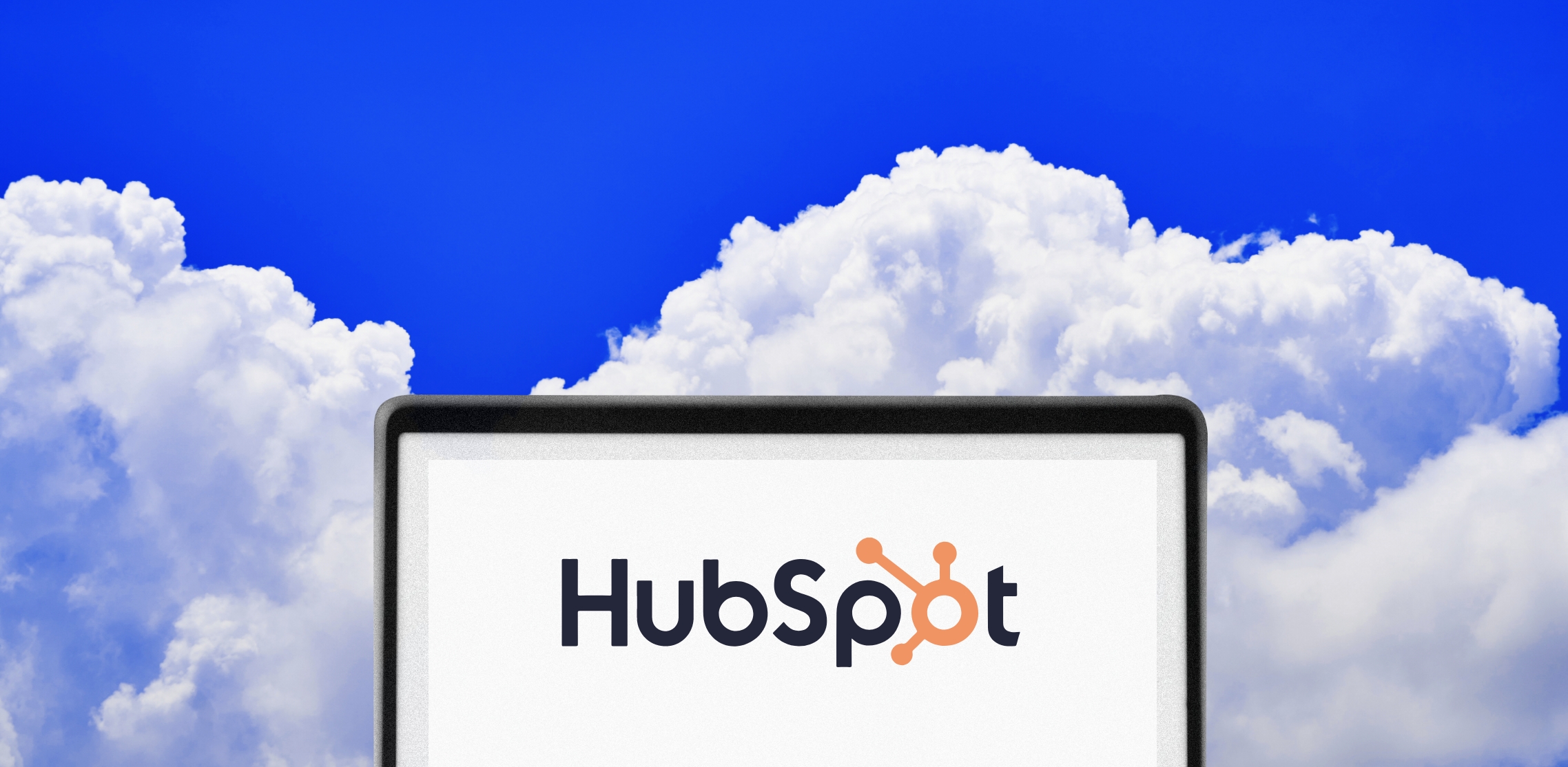 A screen with HubSpot CRM and a cloudy background